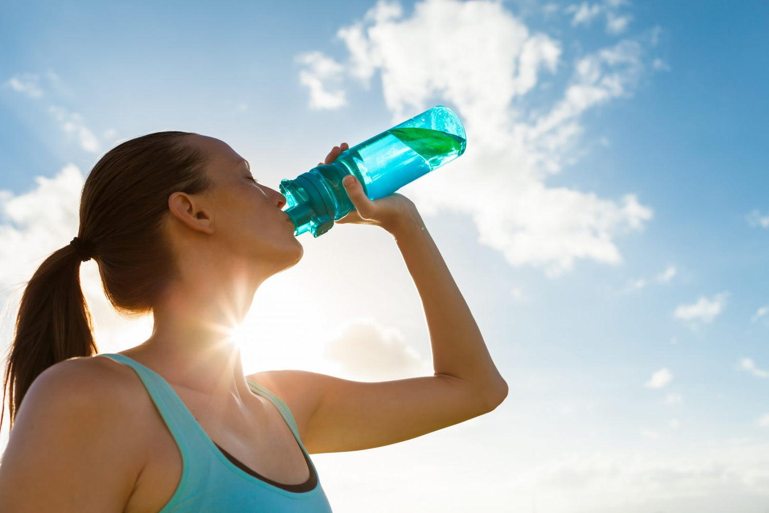 A runner drinking water.