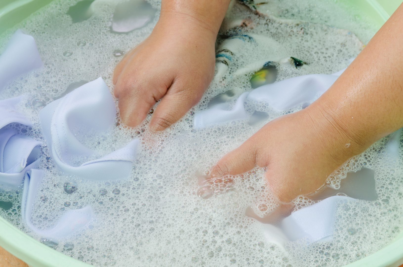 Someone washing silk in a bowl of water